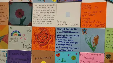 A quilt of artwork panels with hearts, flowers, and messages