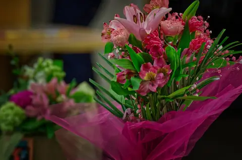 A bouquet of pink lilies and roses