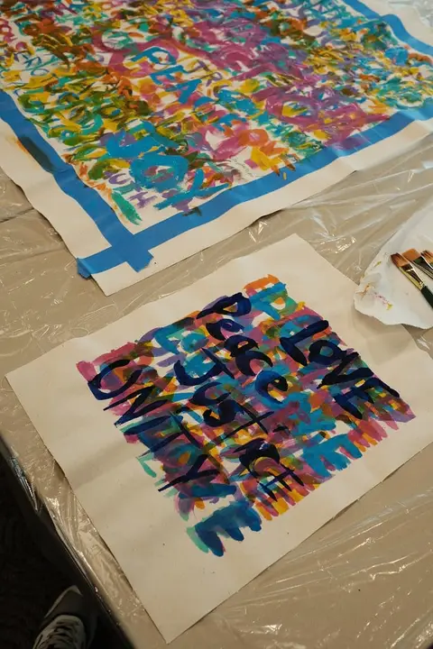 Painted artwork with words of love and unity in bright colors
